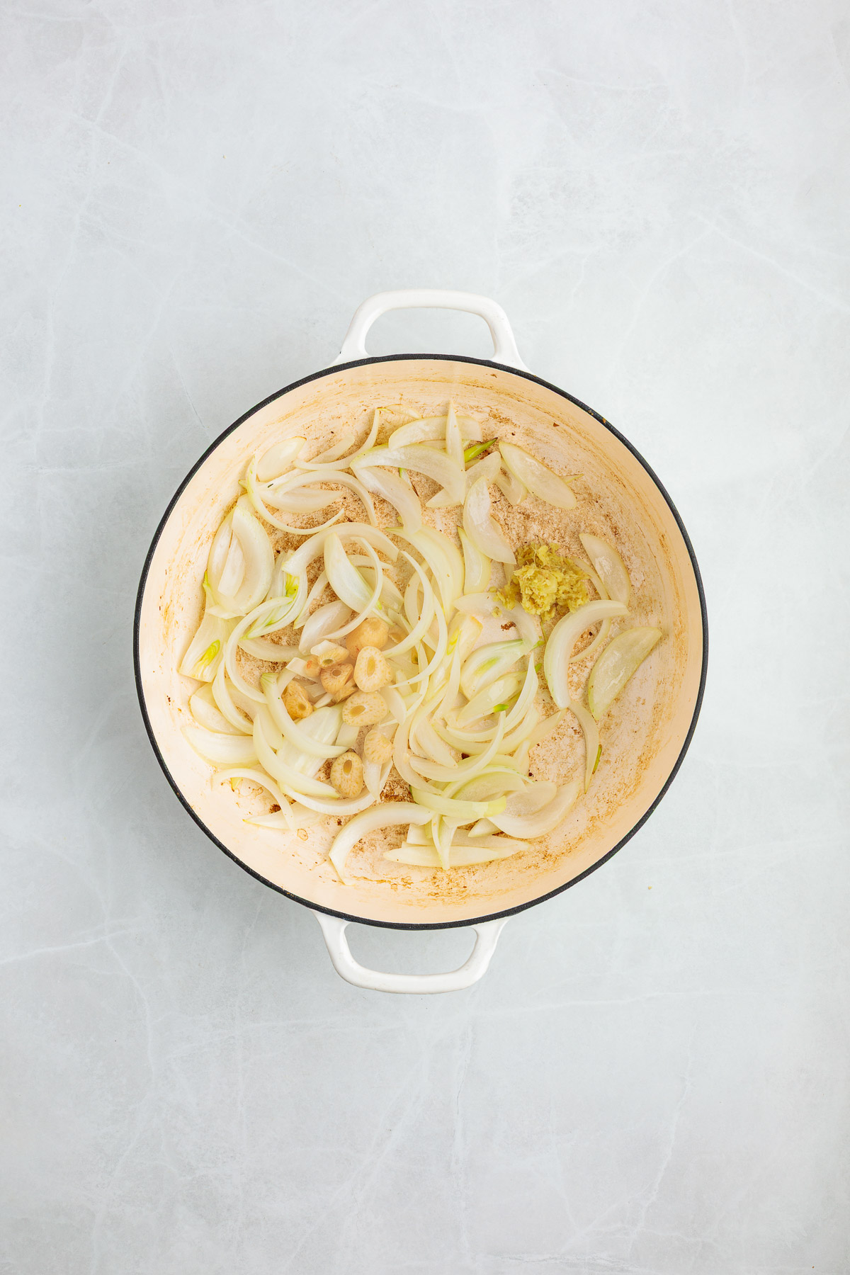 Cooking the onion and garlic in a pot.