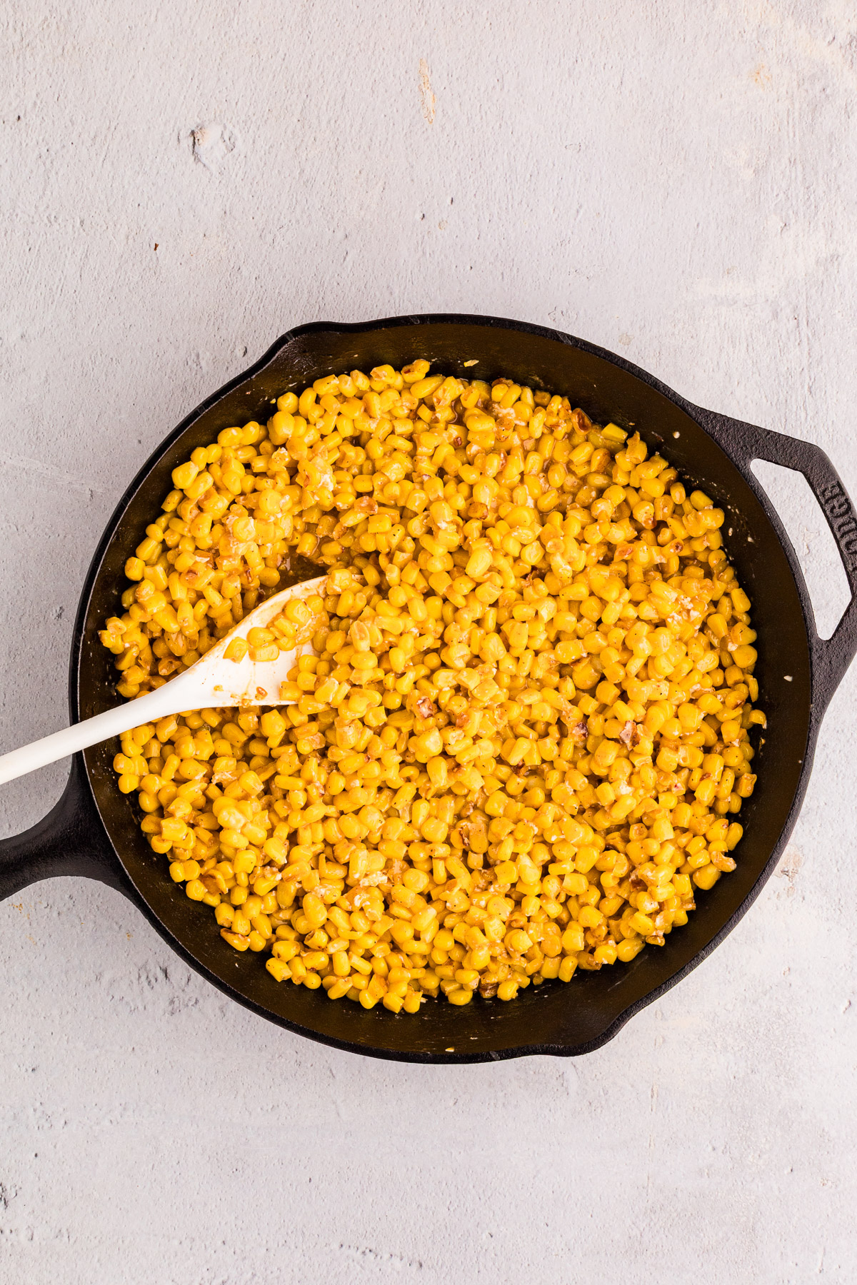 Hot honey butter skillet corn fully combined with creamy sauce coating charred corn kernels