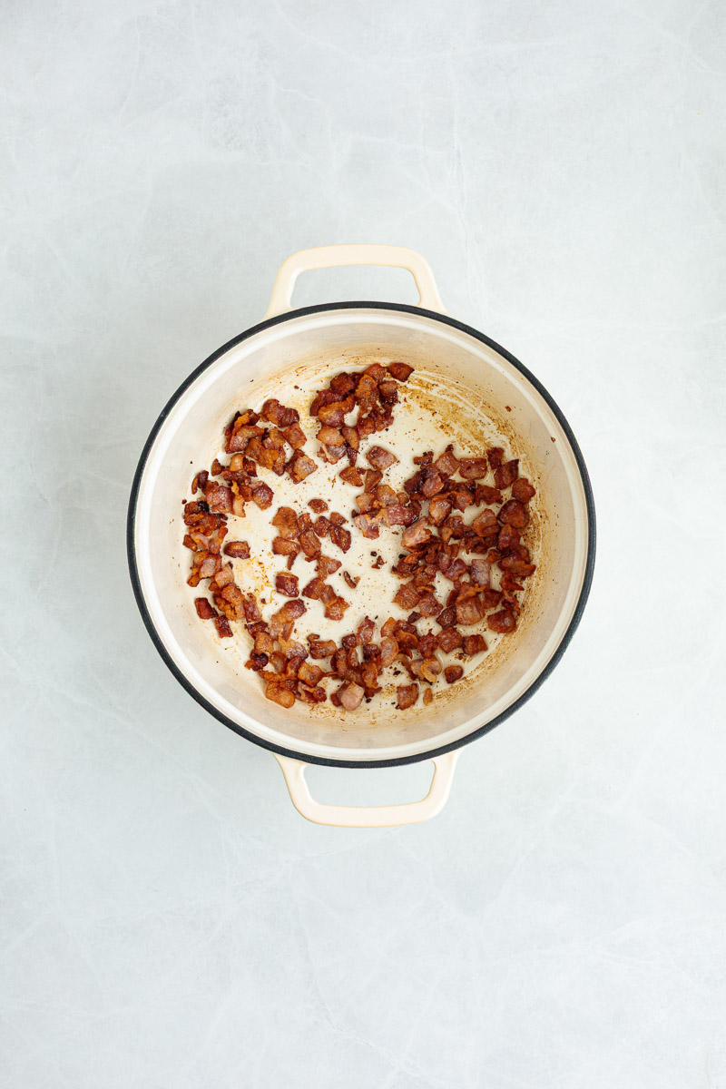 Bacon cooking in the dutch oven.