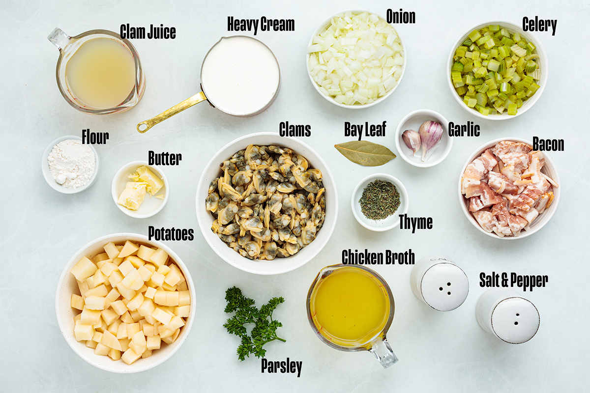 ingredients to make this clam chowder soup on a table.