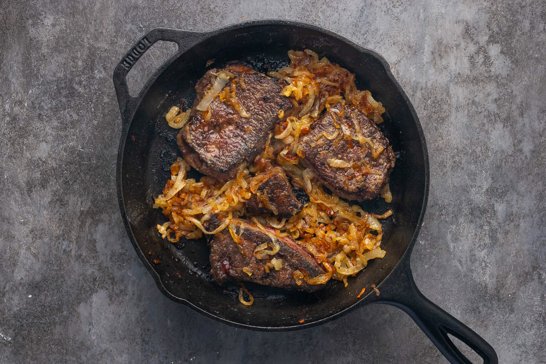 Old fashioned liver and onions finished in cast iron skillet
