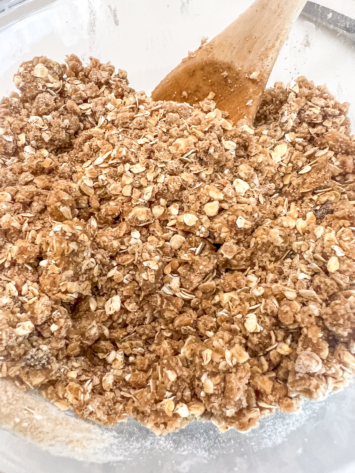 Oats flour brown sugar cinnamon nutmeg baking soda and baking powder in a bowl for apple crisp topping