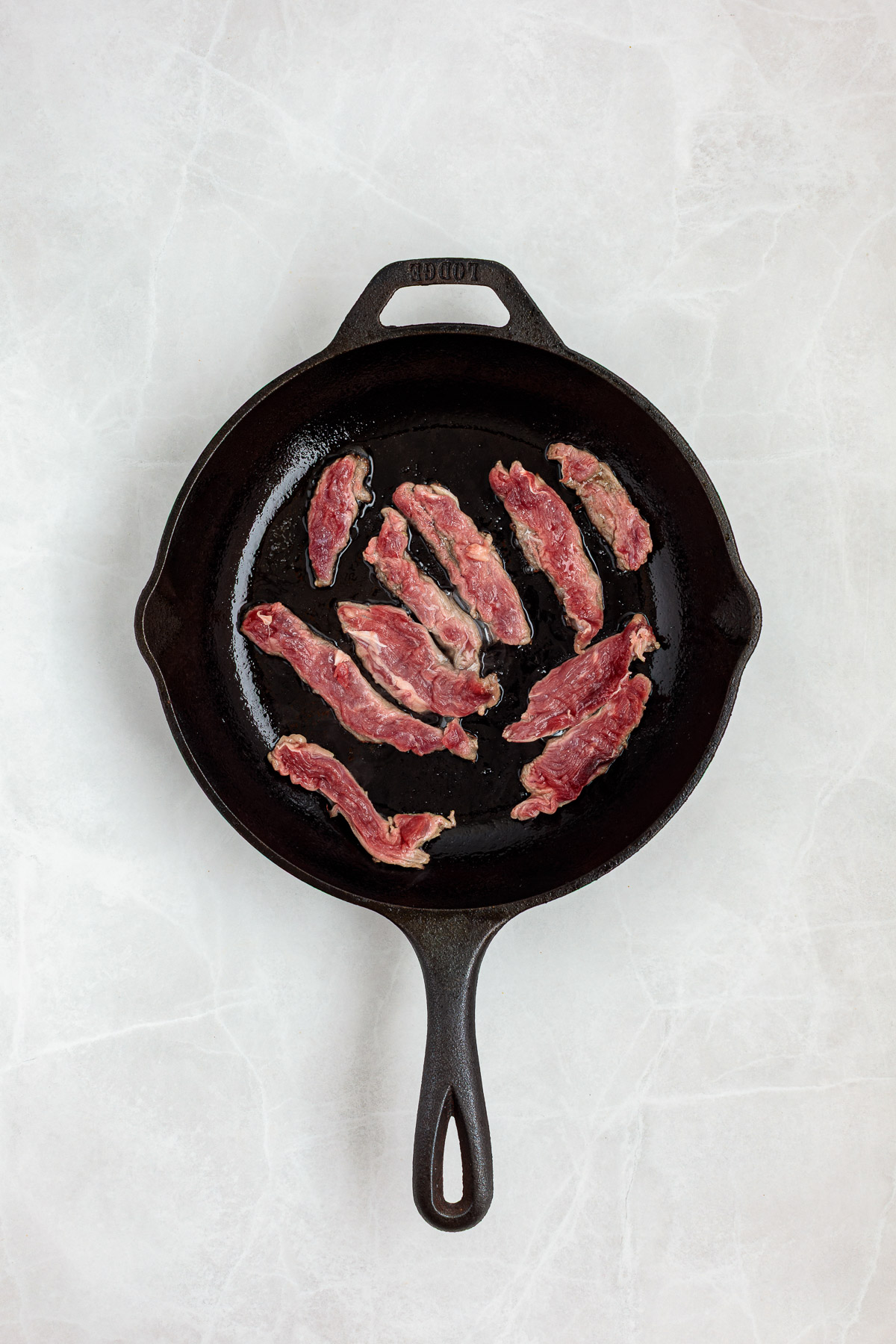 trimmed skirt steak in a cast iron skillet.