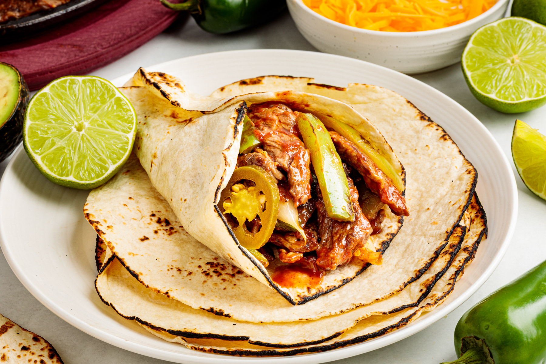 Skillet fajitas served in a warm tortilla.