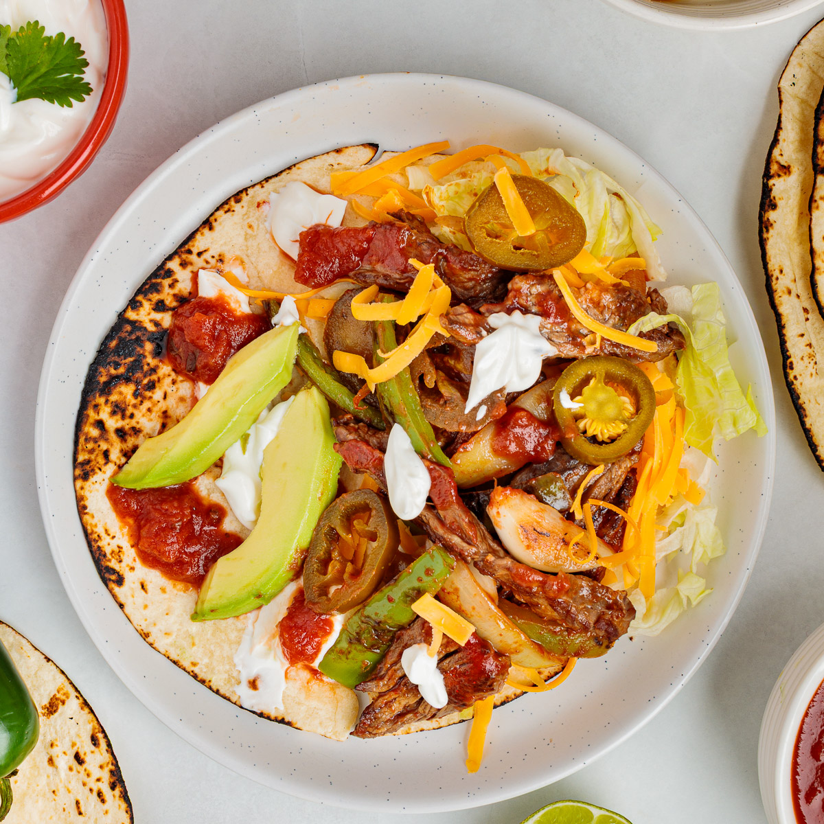 Skillet fajitas with peppers and onions served in a warm tortilla.