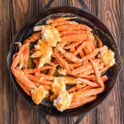 Smoked crab legs in a cast iron skillet.