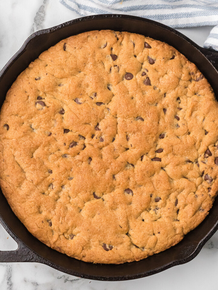 Sourdough Chocolate Chip Cookie ready to be served in a cast iron skillet.