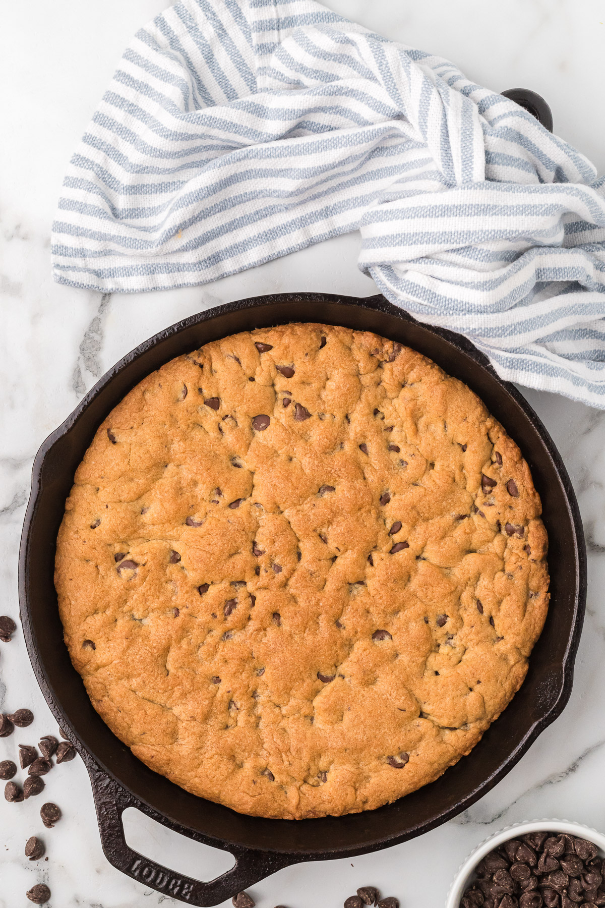 Baked sourdough chocolate chip skillet cookie with golden edges.