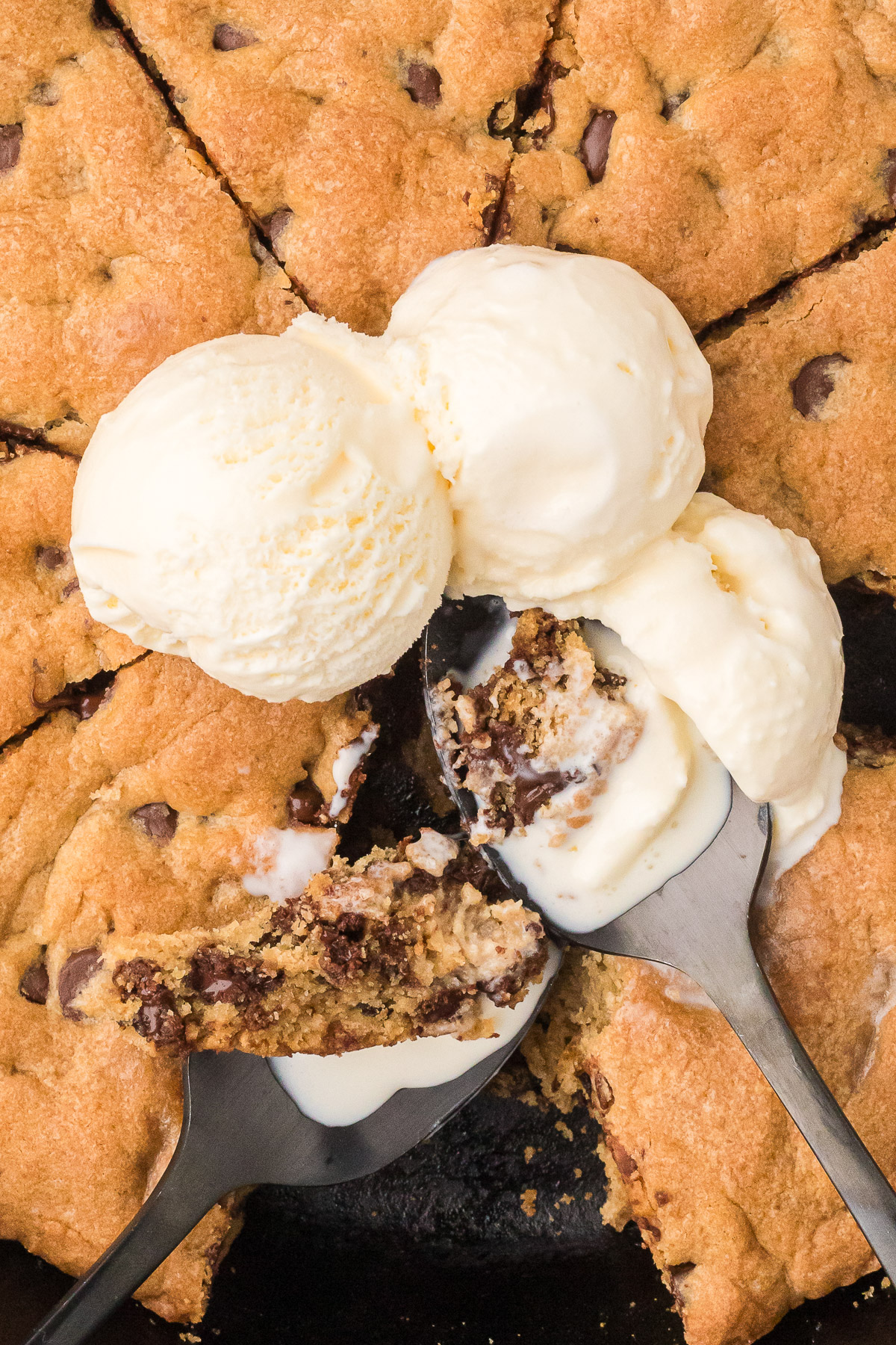 Sourdough Skillet cookie being served topped with vanilla ice cream.