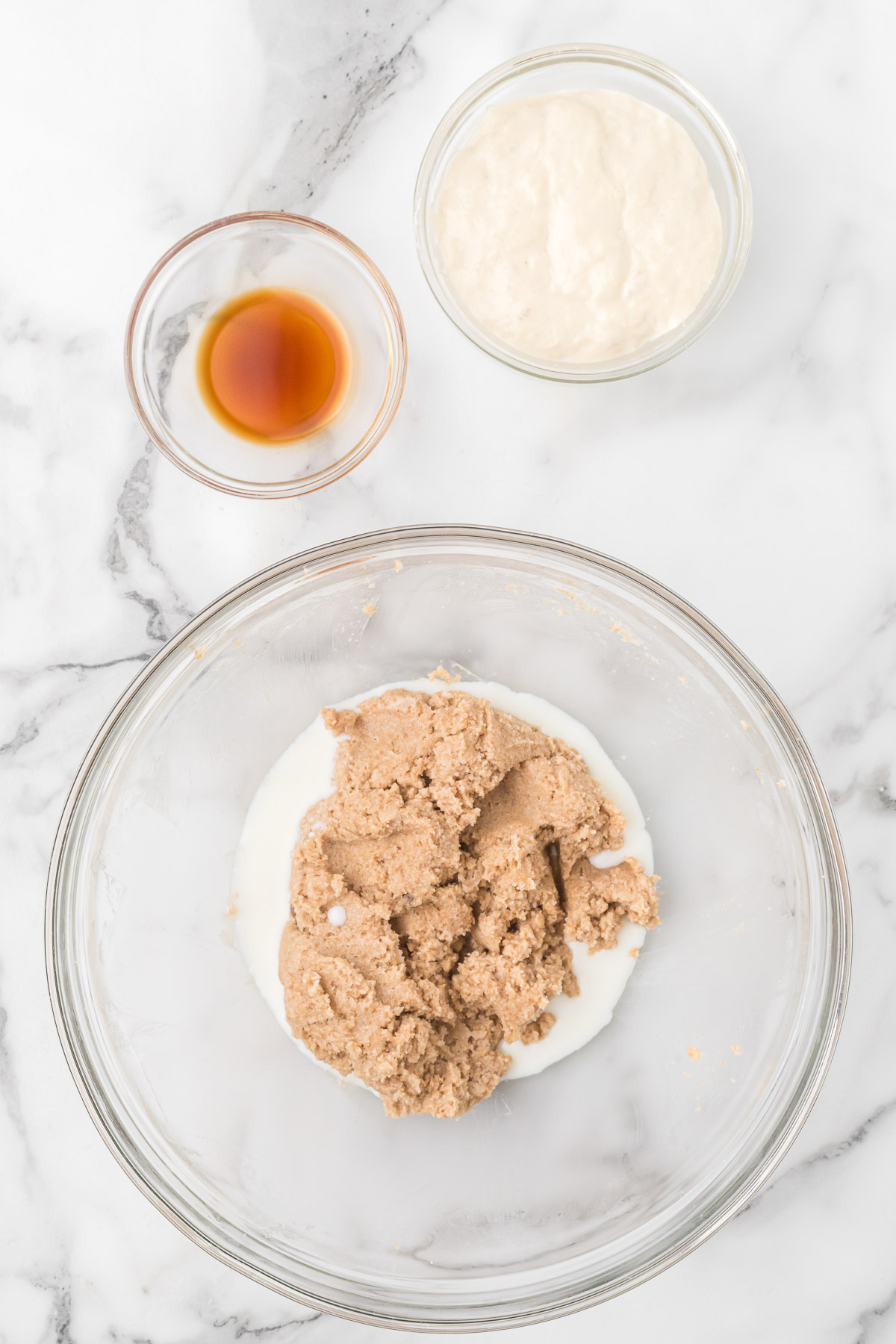 Adding sourdough starter to the cookie dough mixture.