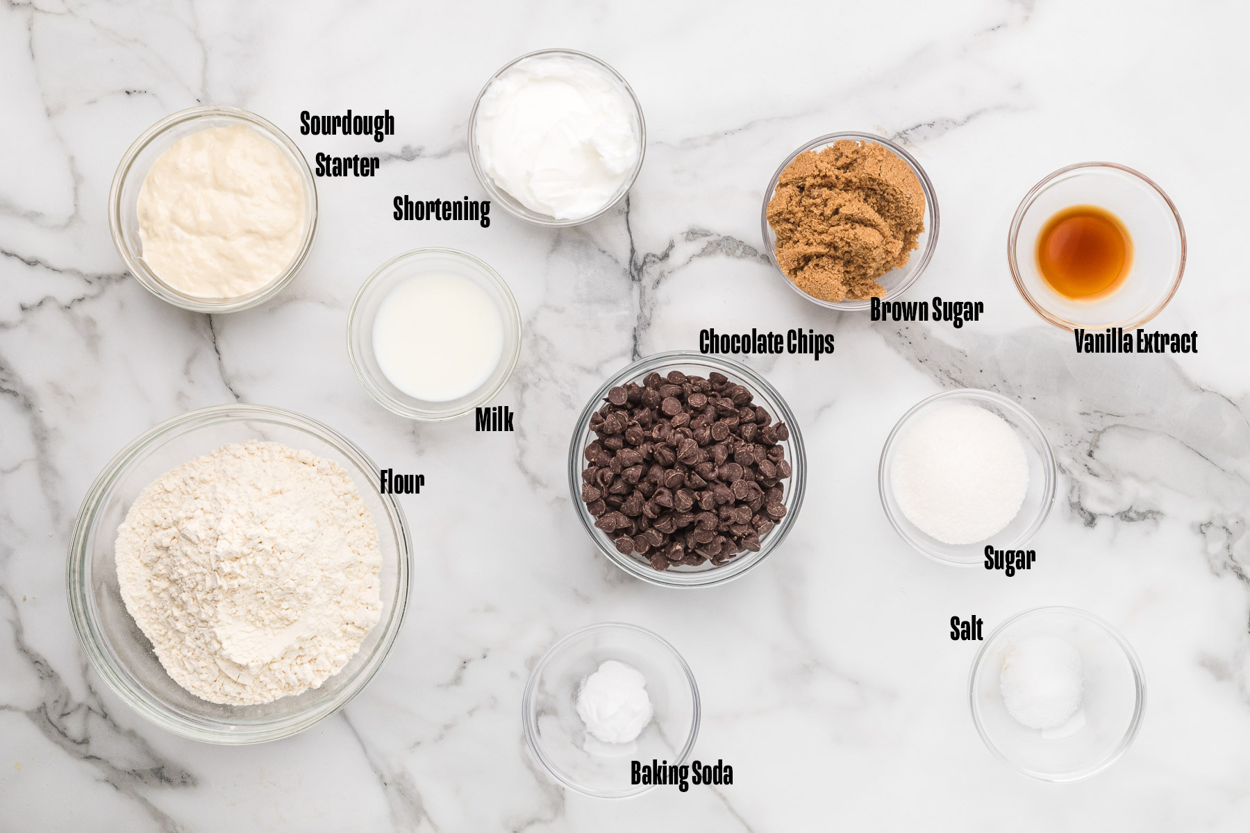 Ingredients to make a sourdough chocolate chip skillet cookie on a table.