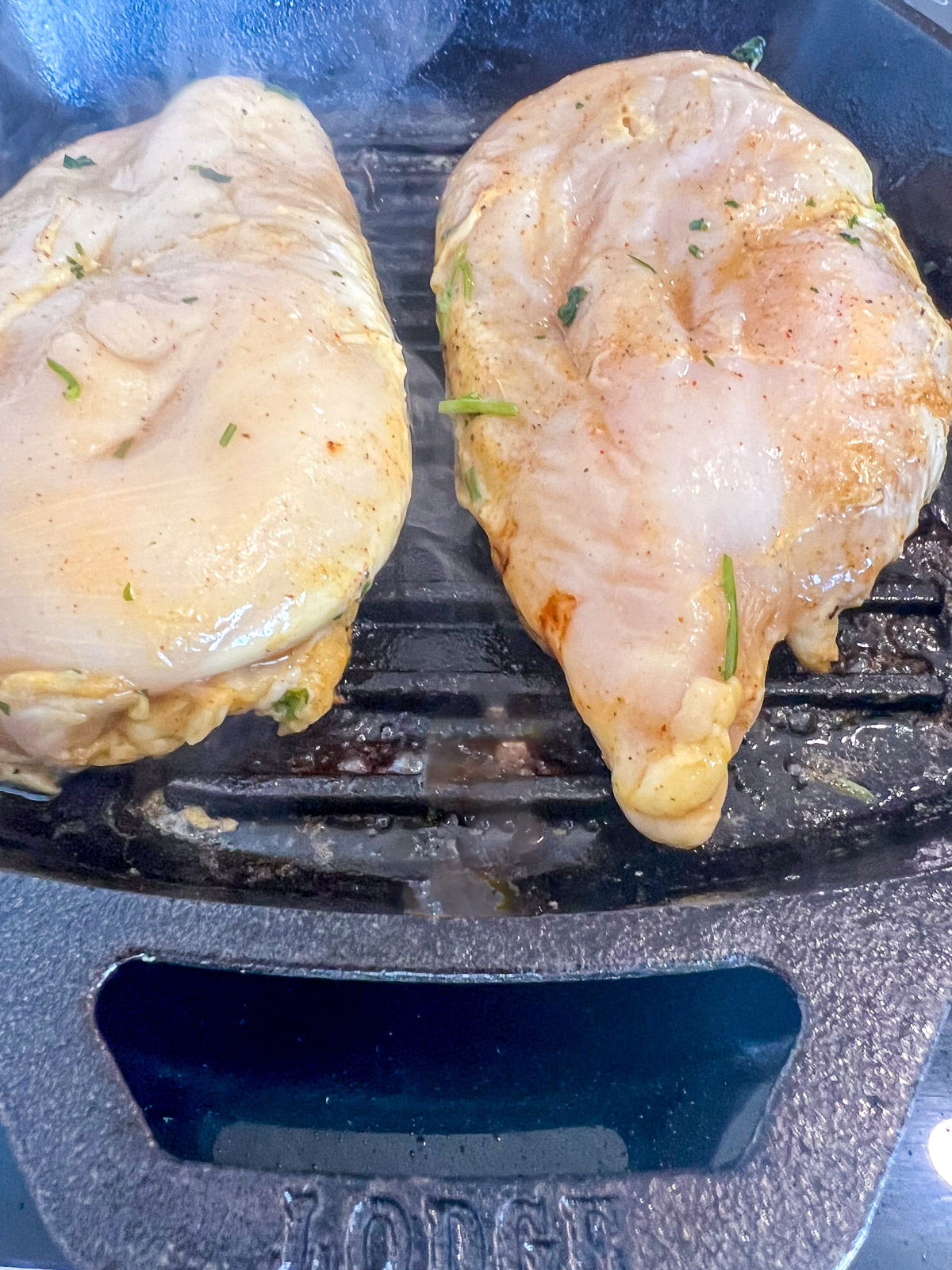 Marinated chicken breasts placed on a Lodge cast iron grill pan ready to cook