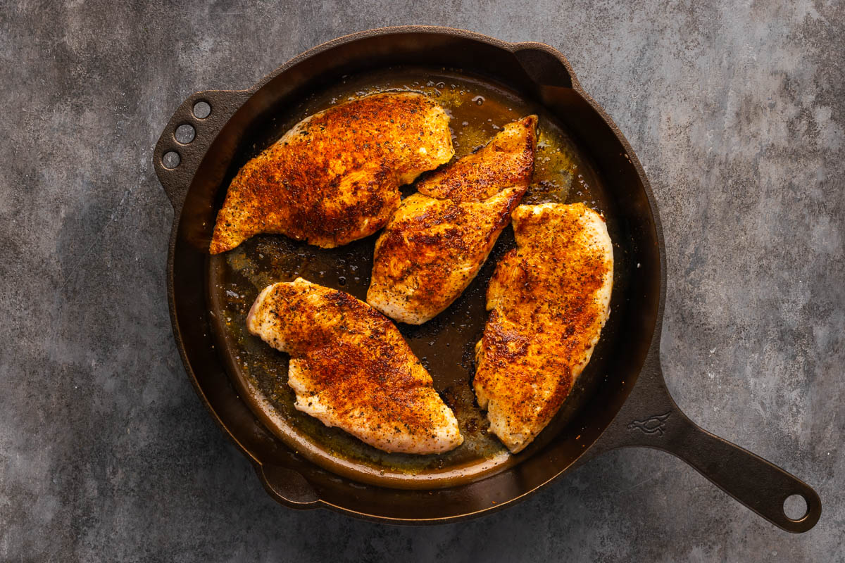 Seared chicken breasts in a skillet. 