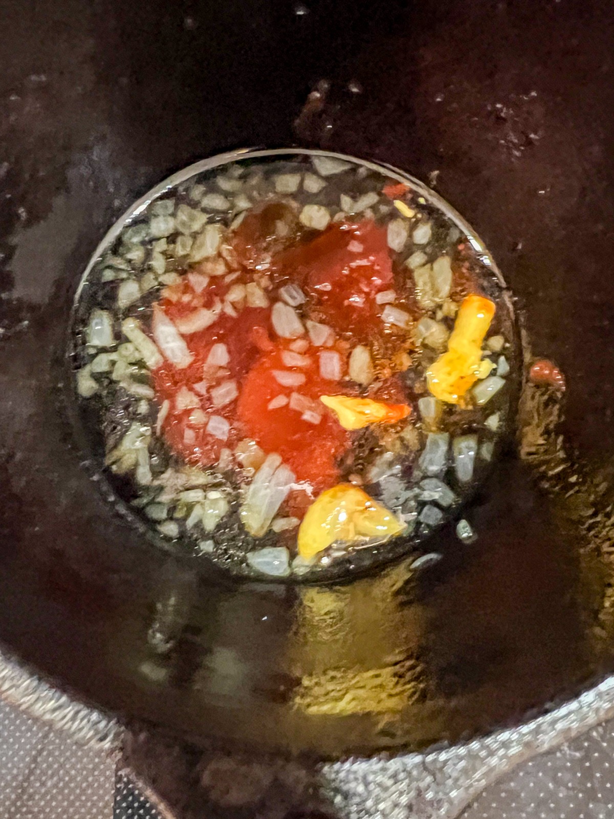 Shallots cooking in butter inside a cast iron skillet to start the maple bourbon glaze.