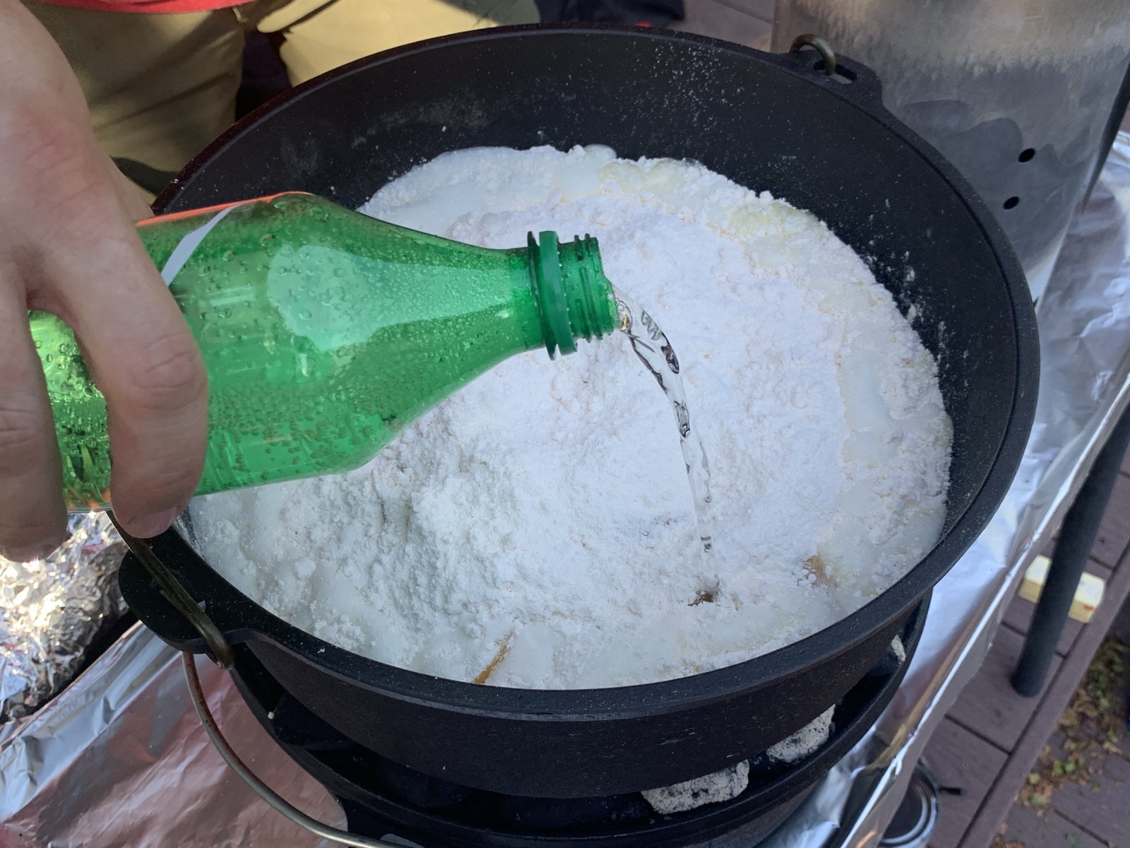 Lemon-lime soda being poured over the cake mix.