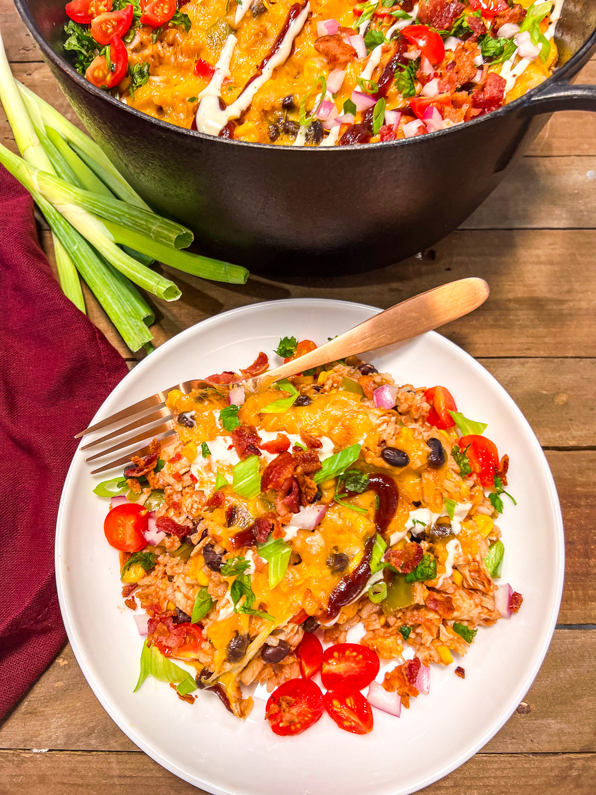 BBQ Chicken and rice served on a white plate with the dutch oven in the background