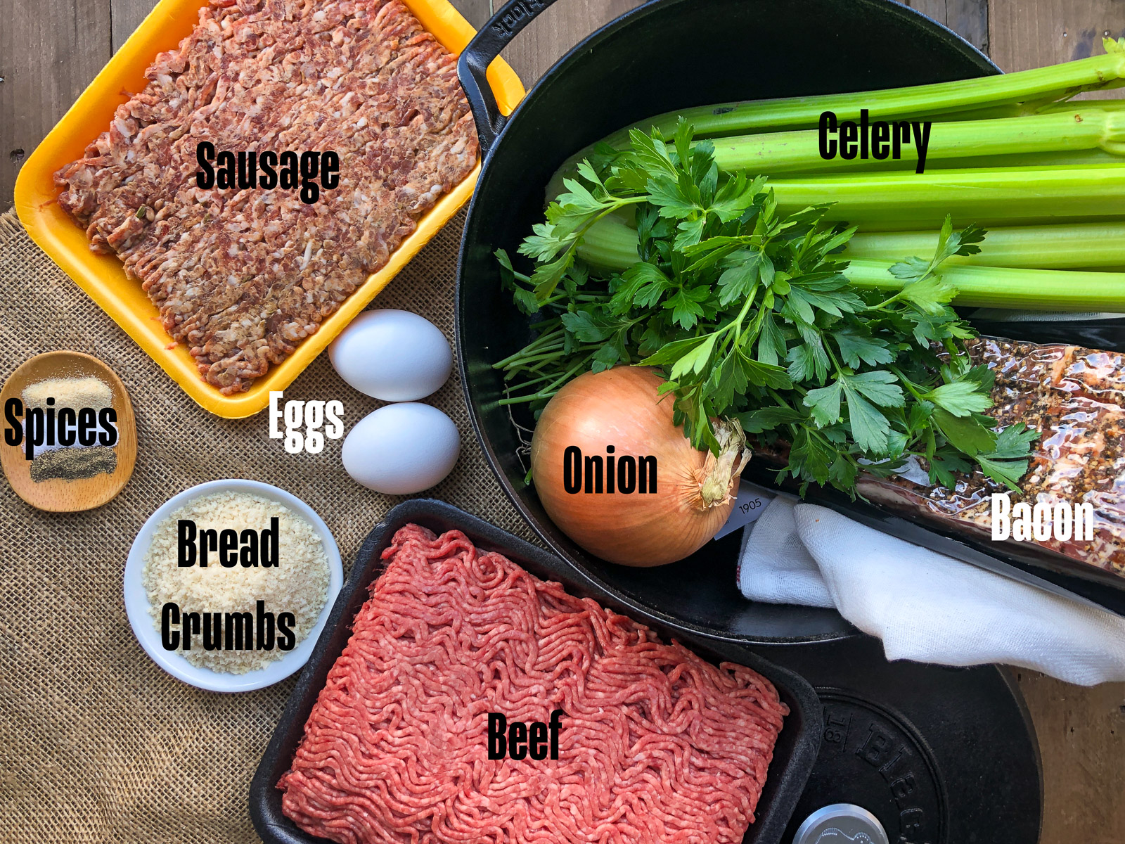 Bacon wrapped meatloaf ingredients laid out on a counter with labels