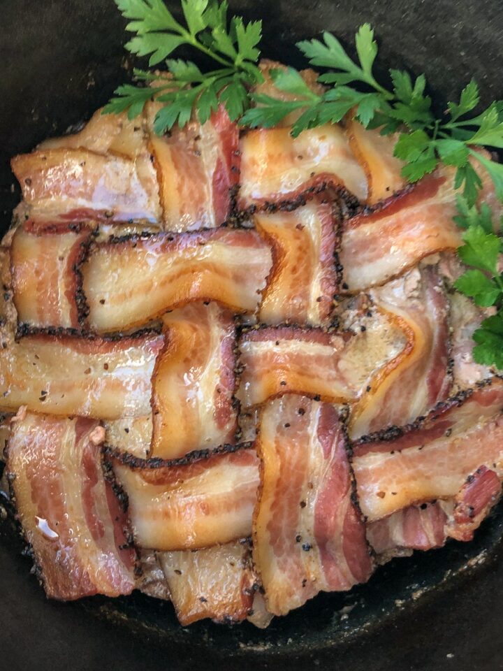 Bacon wrapped meatloaf in a Dutch oven with crispy peppered bacon lattice