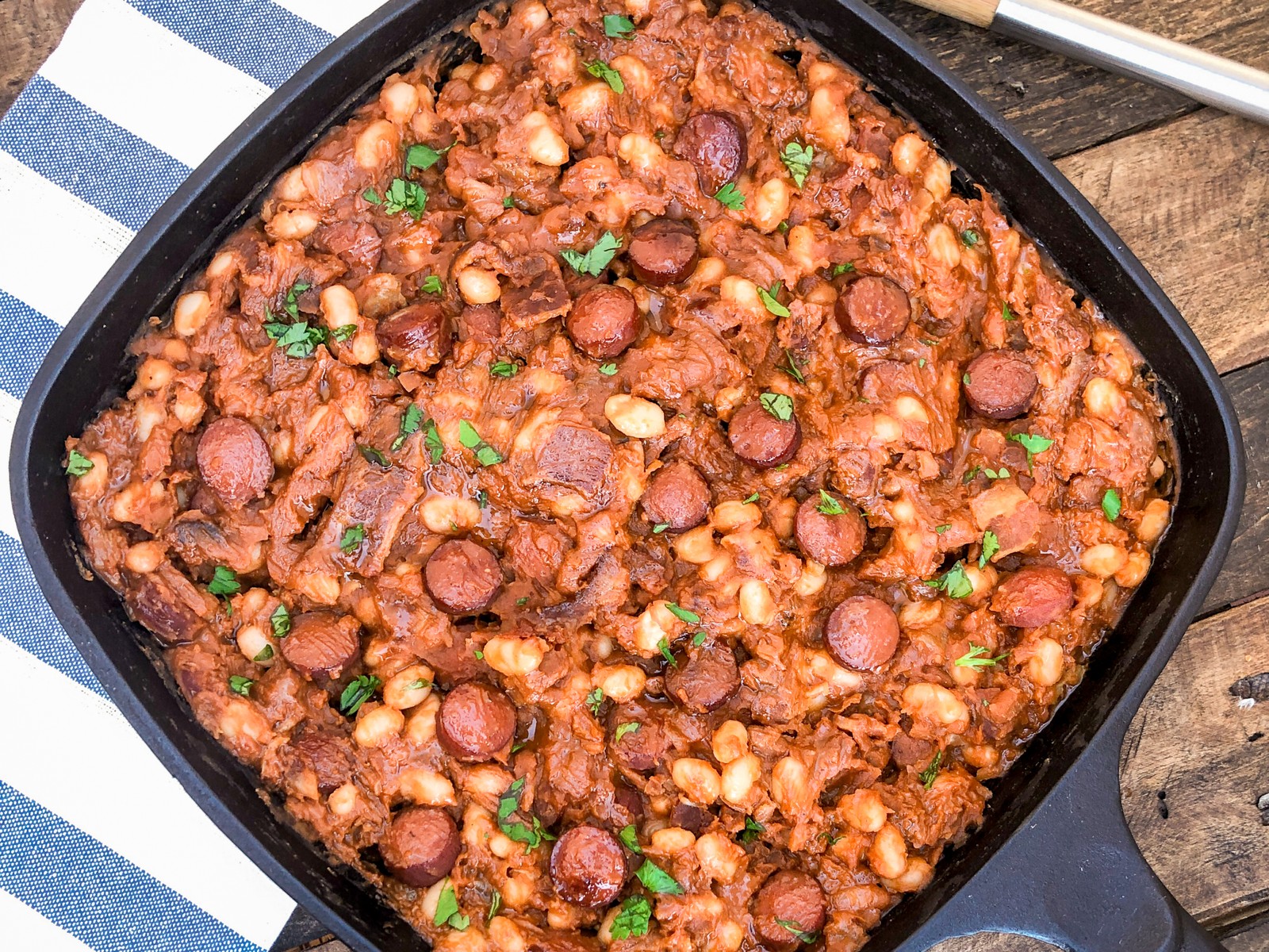 Beanie weenies in a cast iron skillet, ready to serve.