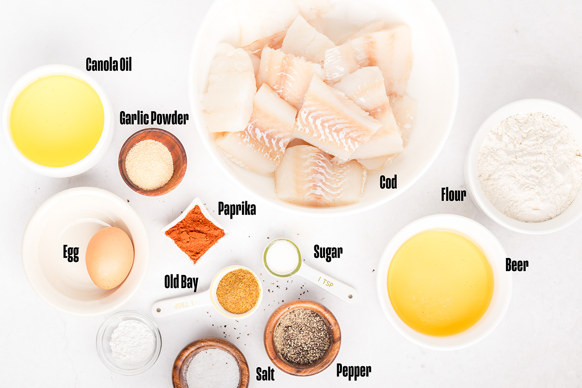 Beer battered fish ingredients: flour, spices, cod fillets, beer, egg, and oil