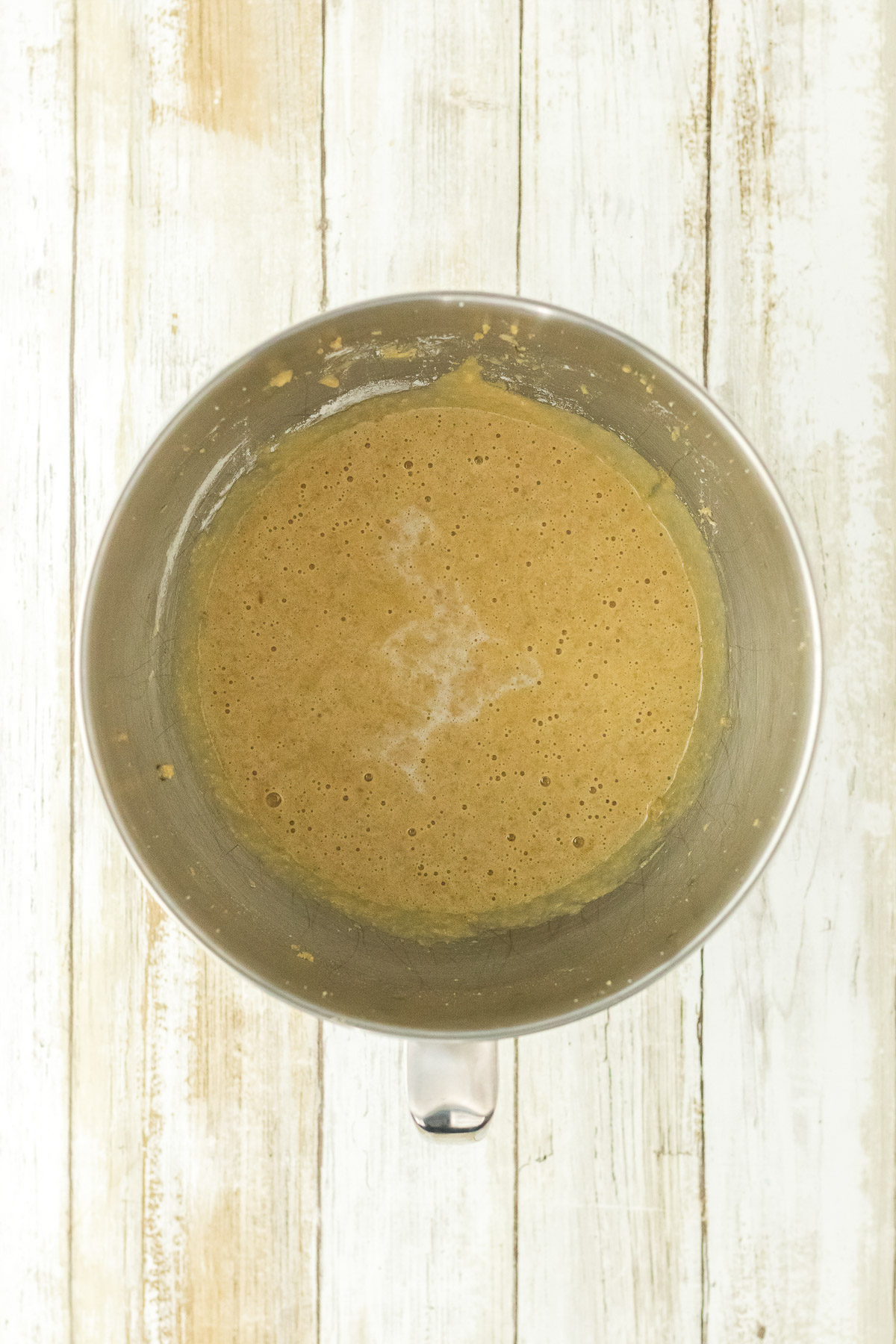 Smooth brown sugar cake batter in a stand mixer bowl