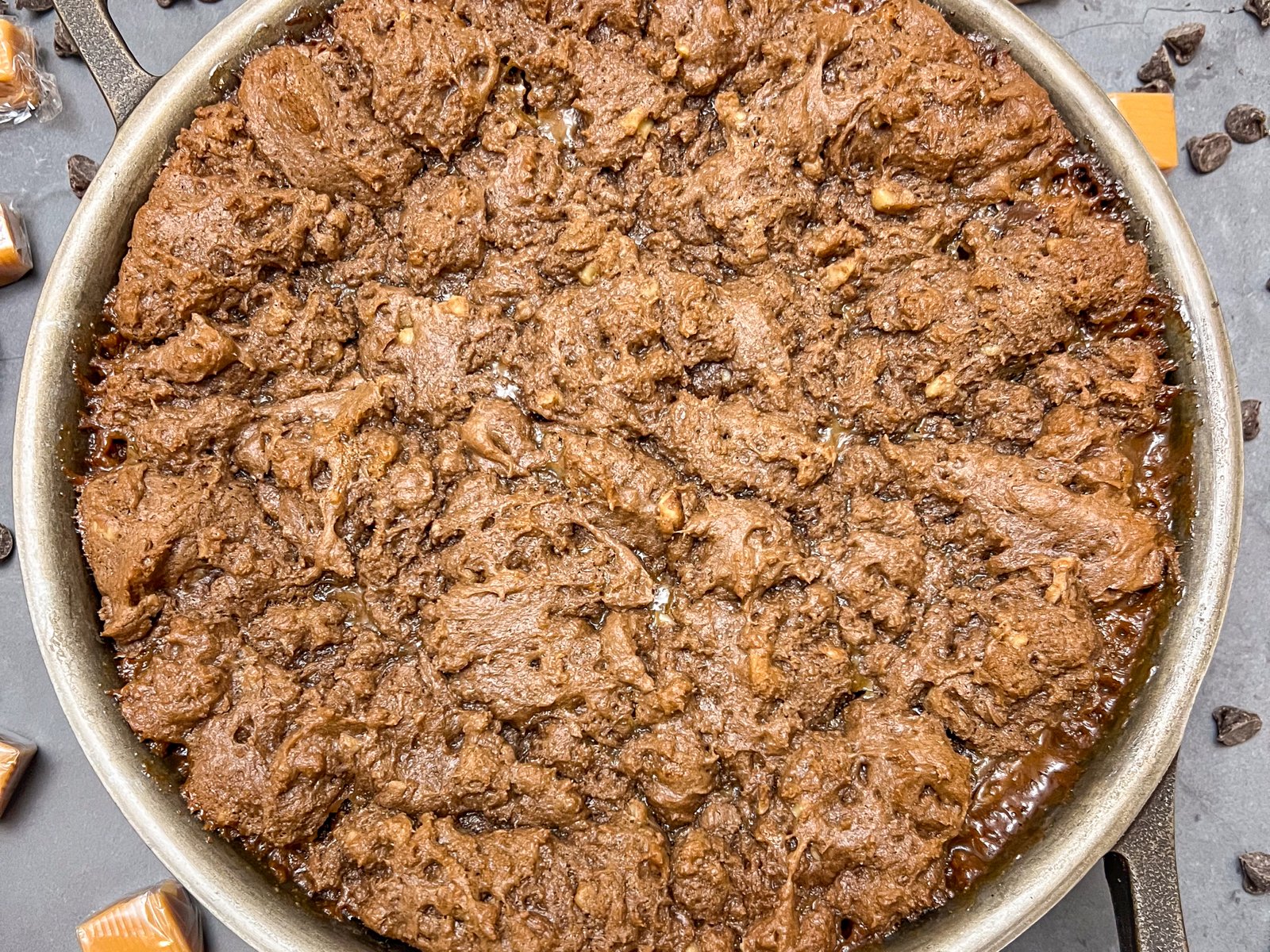 Caramel brownies freshly baked in a cast iron skillet.
