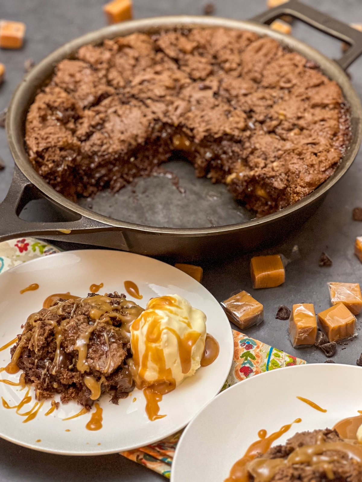 Caramel brownies served with vanilla ice cream and a drizzle of caramel sauce.