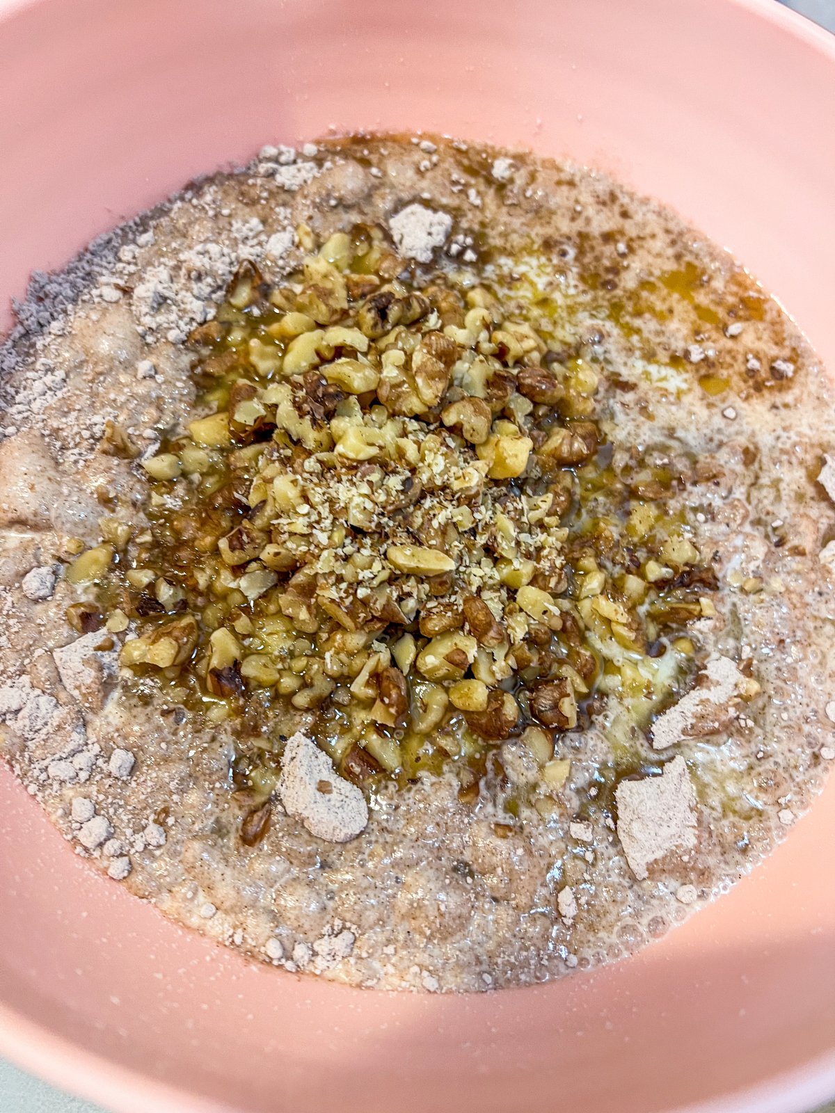 German chocolate cake mix, walnuts, evaporated milk, and melted butter in a mixing bowl.