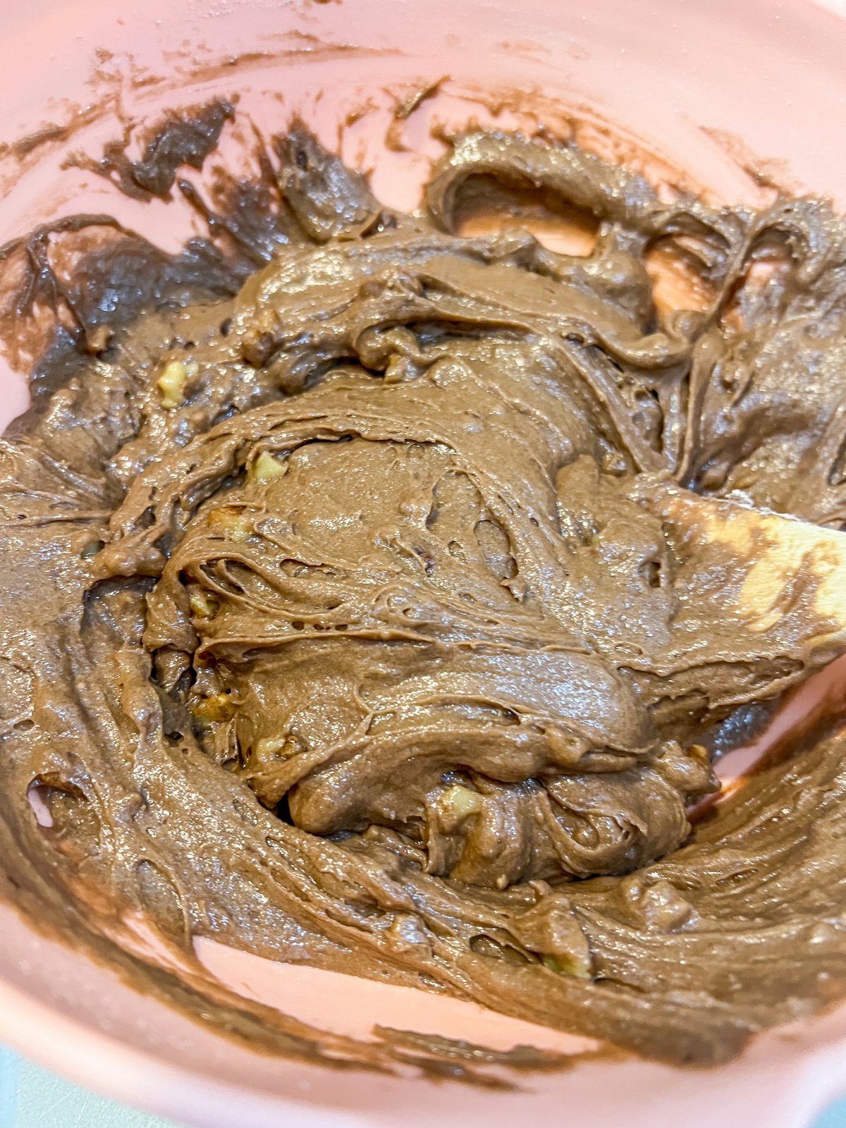 Thick brownie batter mixed together in a bowl.