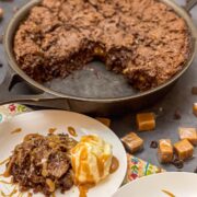 Caramel brownies plated with ice cream and caramel drizzle