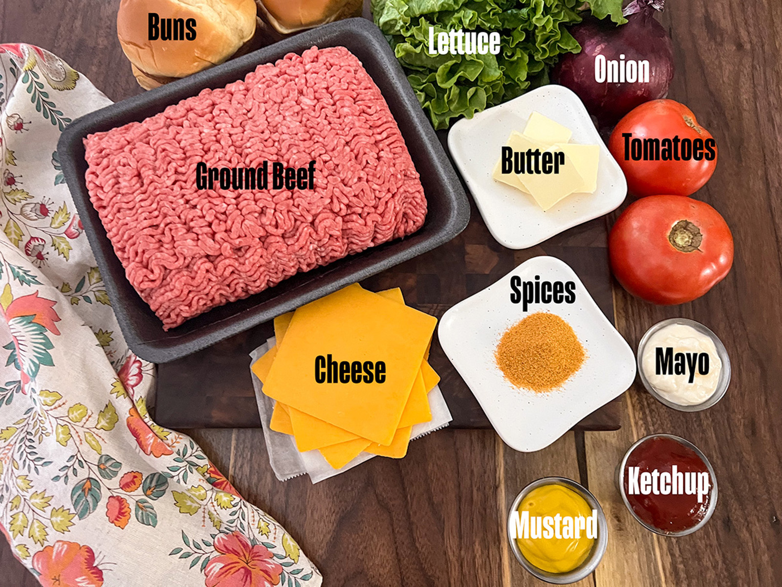 Ingredients to make cast iron skillet burgers on a table.