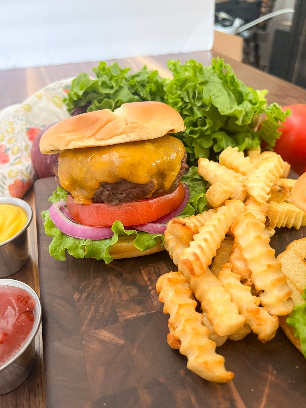 Cast iron skillet burger with fries on the side.
