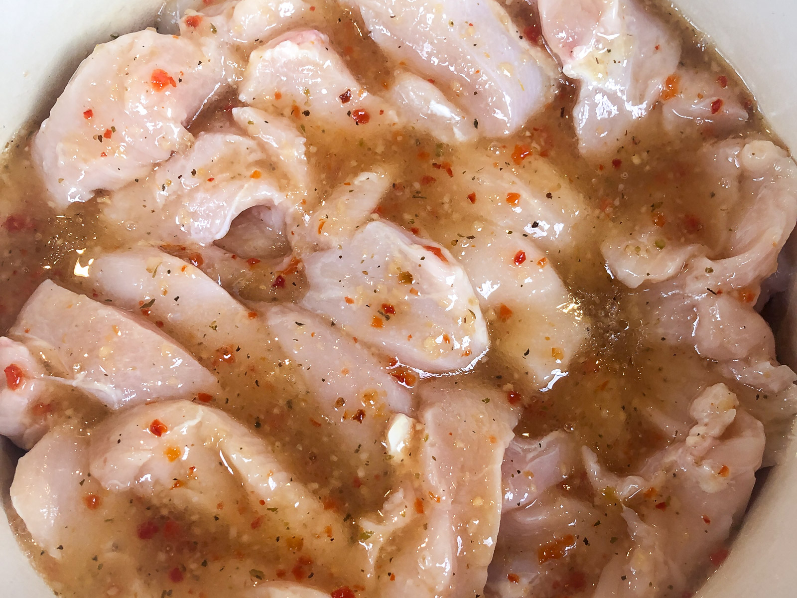 Chicken strips and Italian salad dressing added on top of the carrots in the Dutch oven.