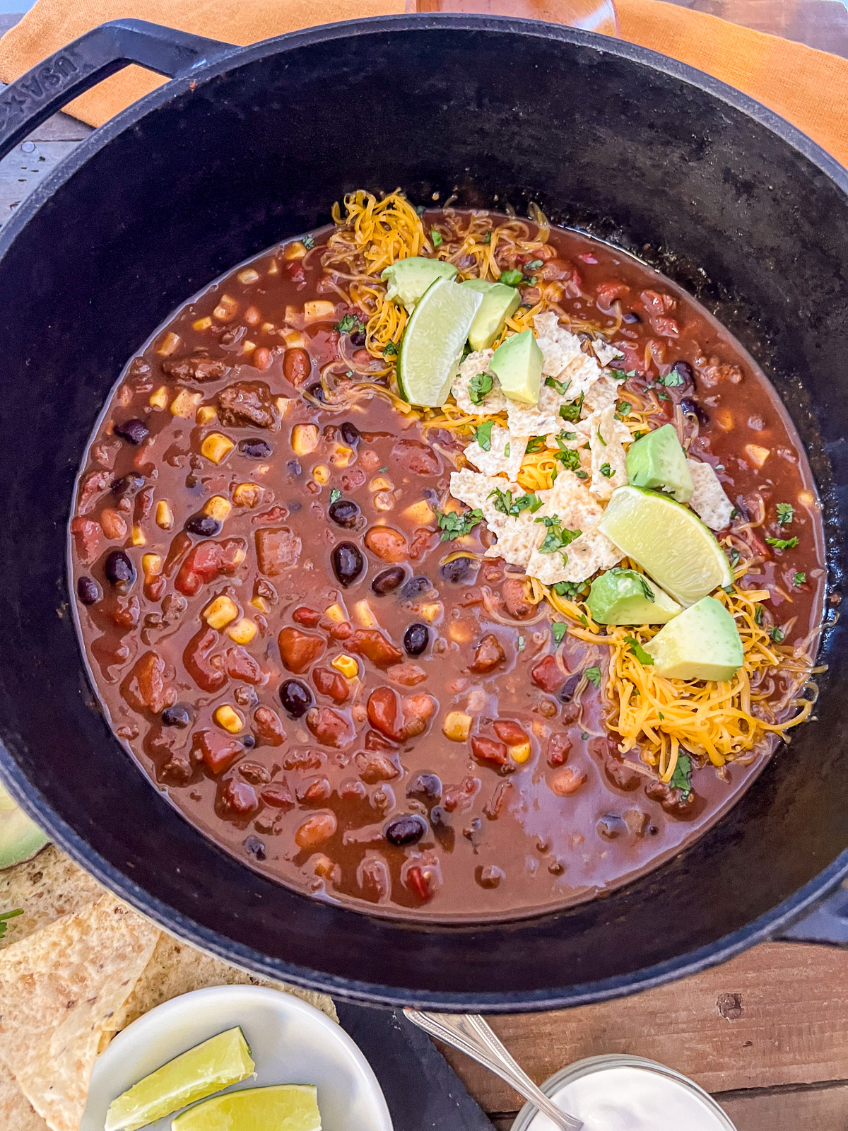 Side view of dutch oven 7 can soup in a white bowl with toppings