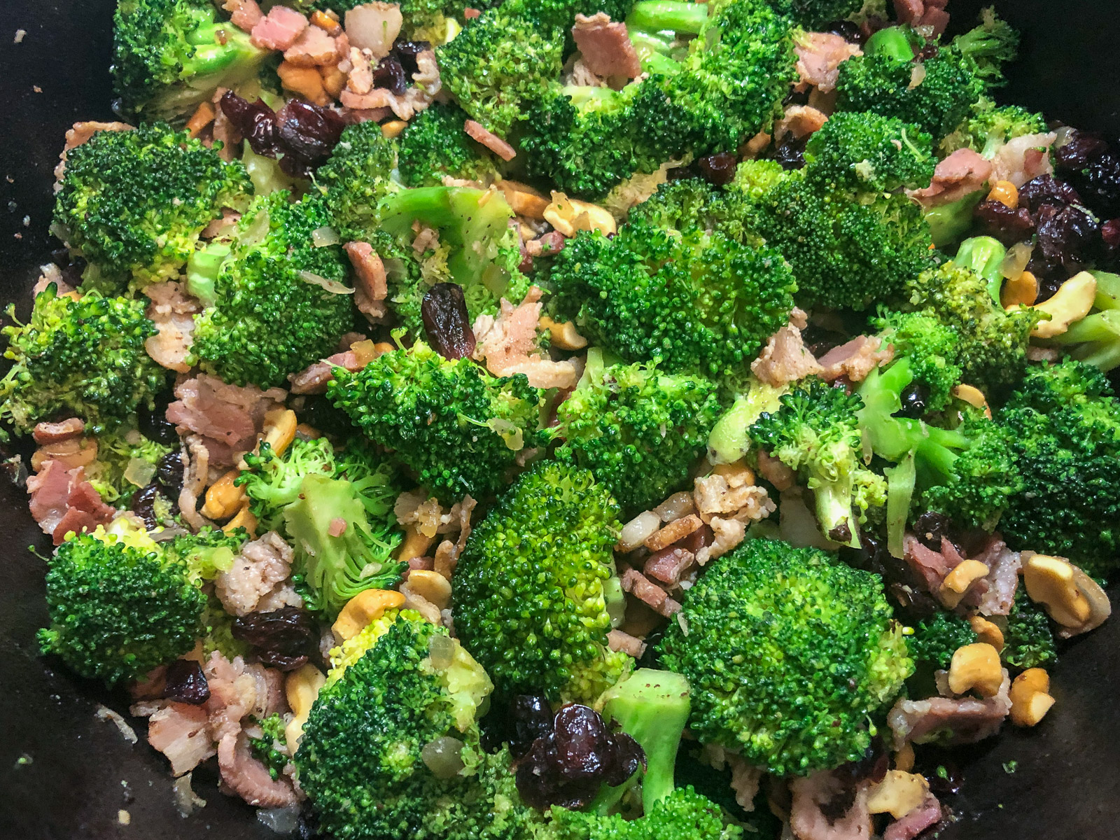Cashews and dried cranberries added to the steamed broccoli in the Dutch oven