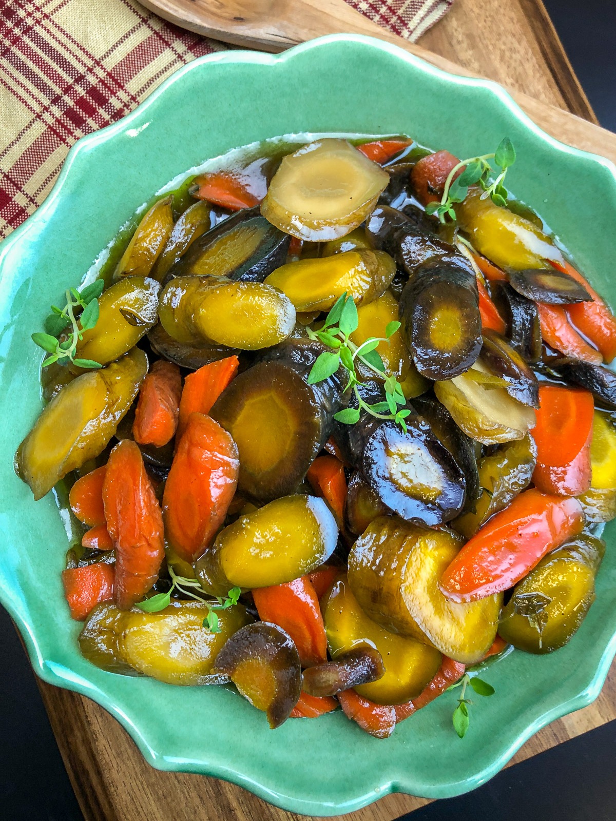 Honey glazed carrots glistening with a sticky butter and honey glaze in a Dutch oven