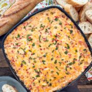 Hot pimento cheese dip baked in a cast iron skillet with golden bubbly top