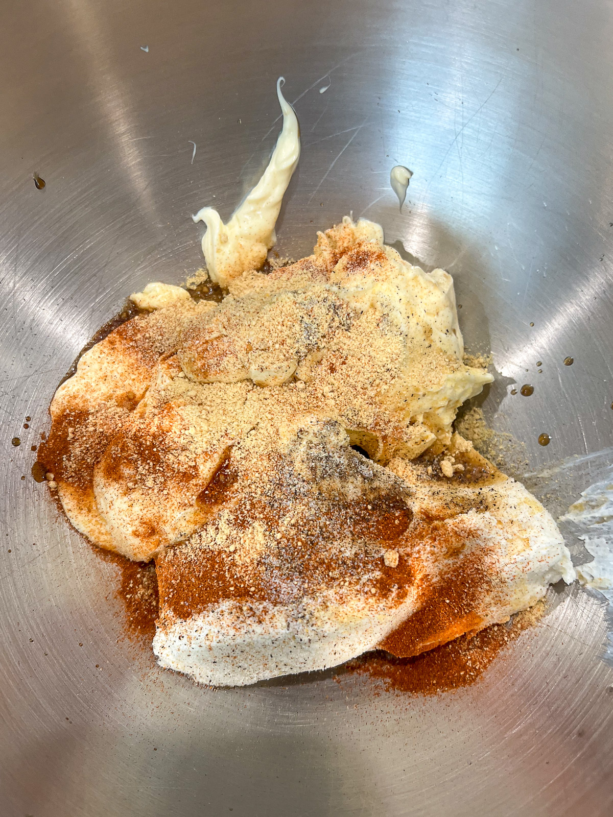 Cream cheese, mayonnaise, and seasonings in a stainless steel mixing bowl