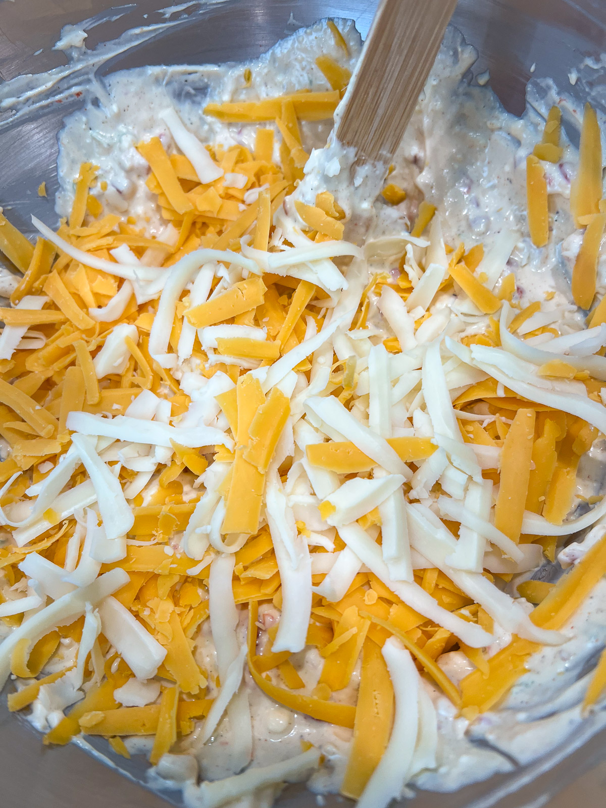 Bacon, green onions, pimentos, and roasted red peppers folded into the cream cheese mixture