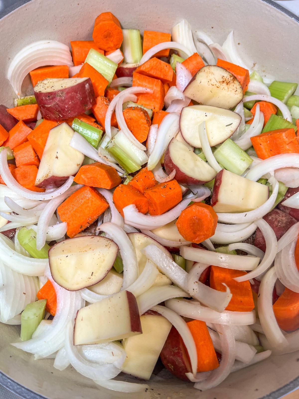 Seared roast back in the Dutch oven with vegetables and beef broth added.
