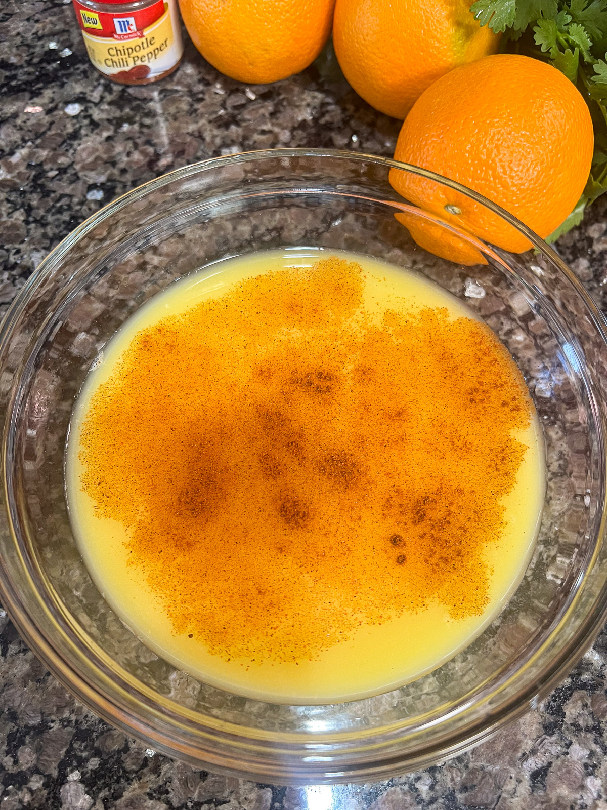 Chipotle powder and orange juice in a bowl.
