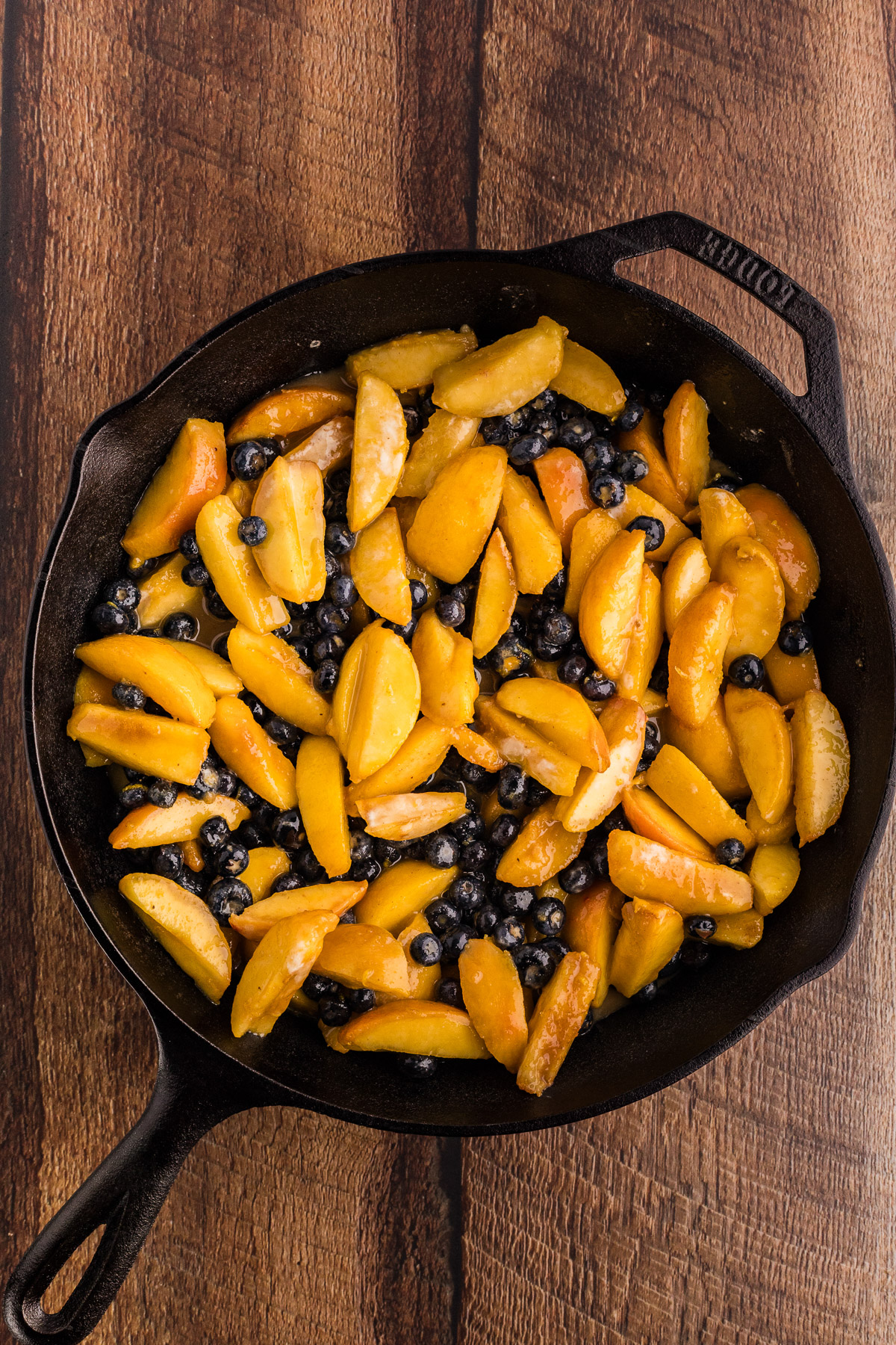 Peach and blueberry filling in a cast iron skillet