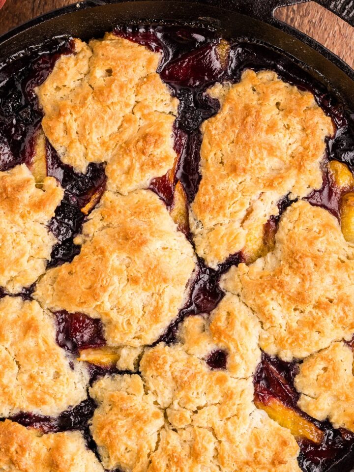 Peach blueberry cobbler baked in a cast iron skillet