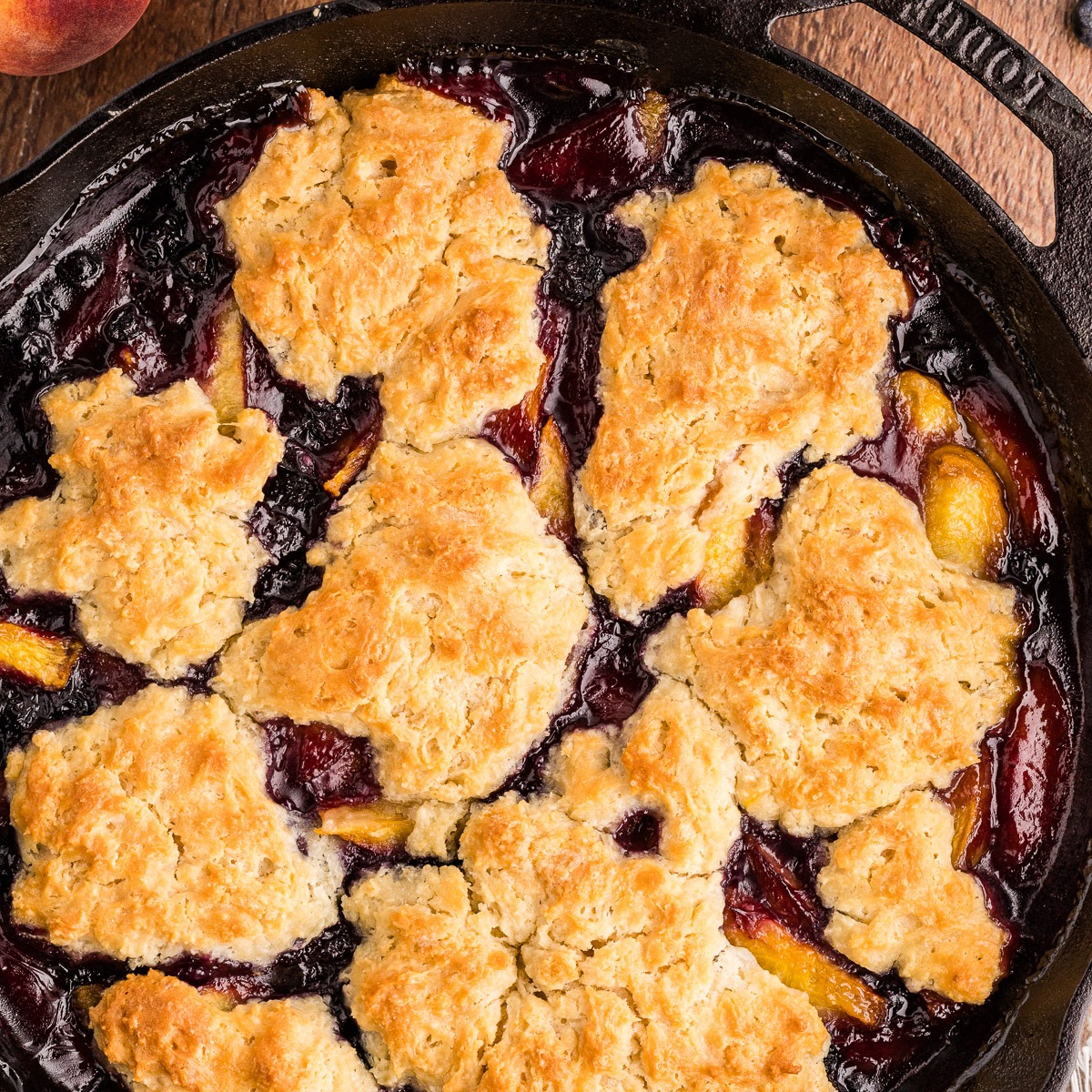 Peach blueberry cobbler baked in a cast iron skillet