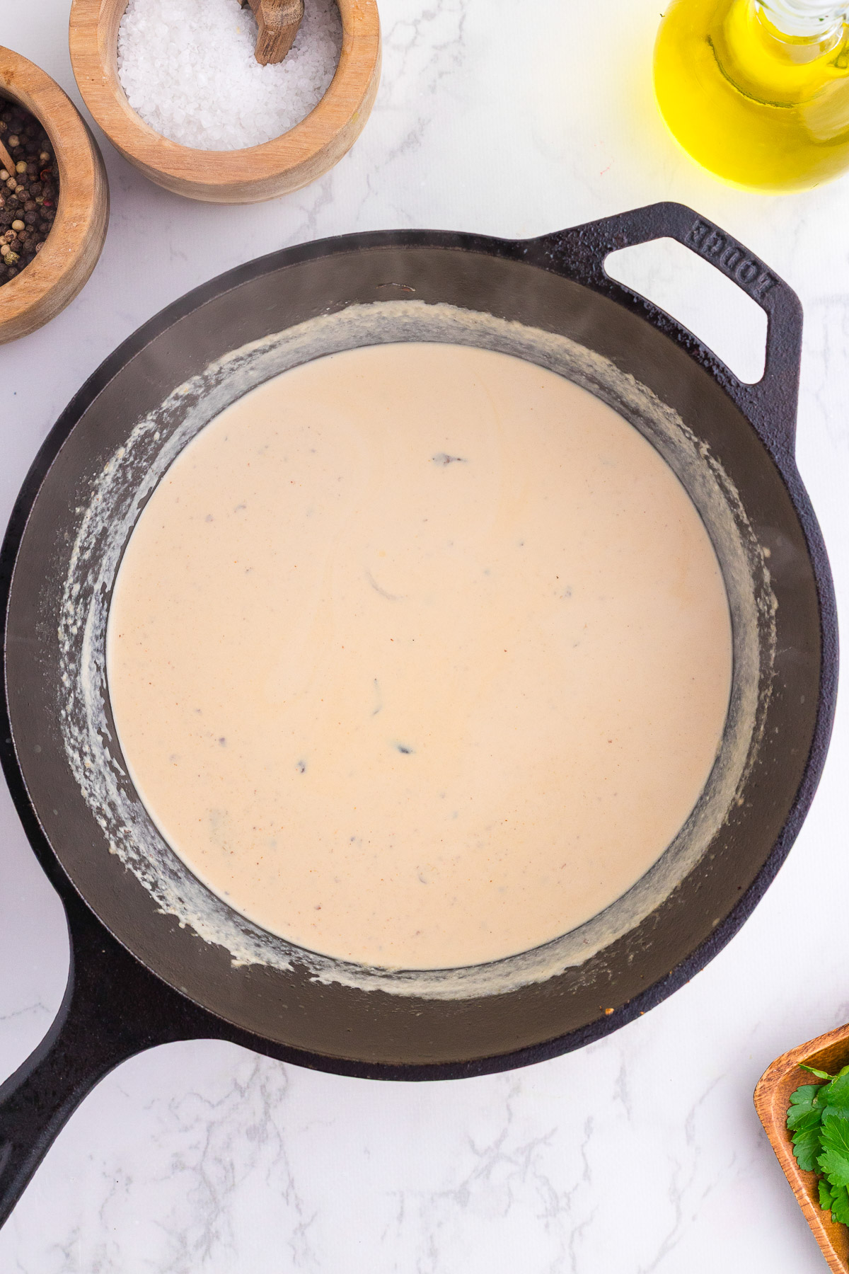 Creamy provolone cheese sauce in a cast iron skillet