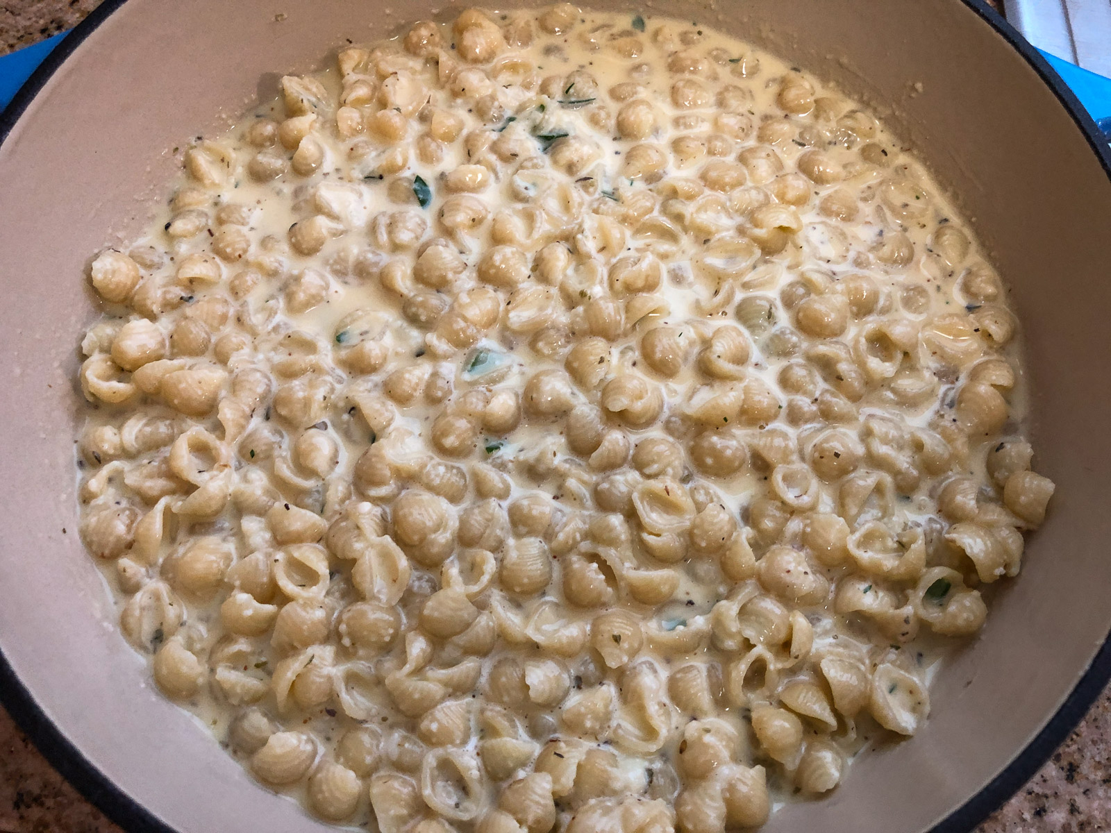 Pasta and egg mixture smoothed into the Dutch oven, ready for the sauce layer.
