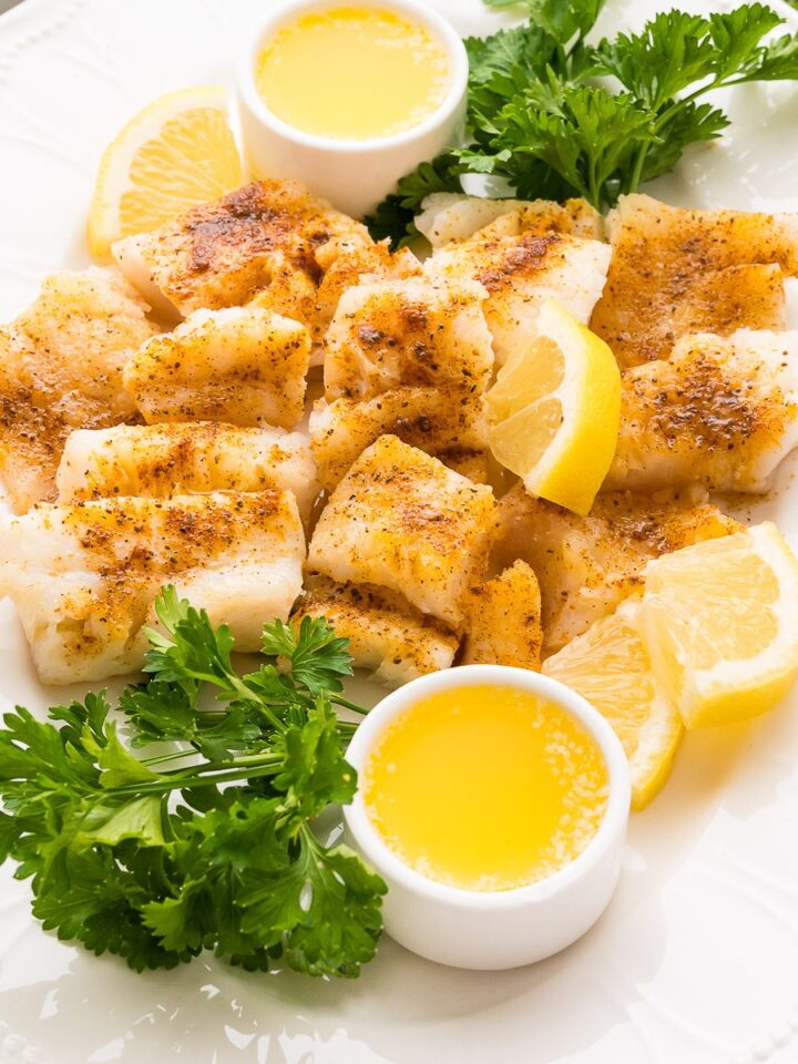 Poor man's lobster cod on oval platter with butter and lemon