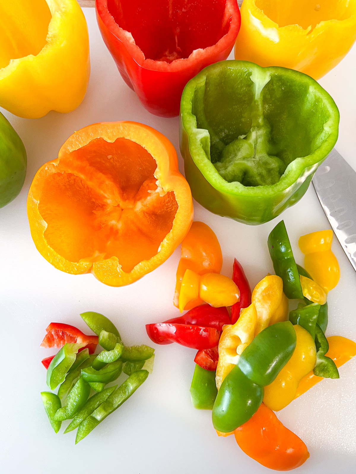 Bell peppers prepped for stuffing with tops removed, de-seeded and deveined.