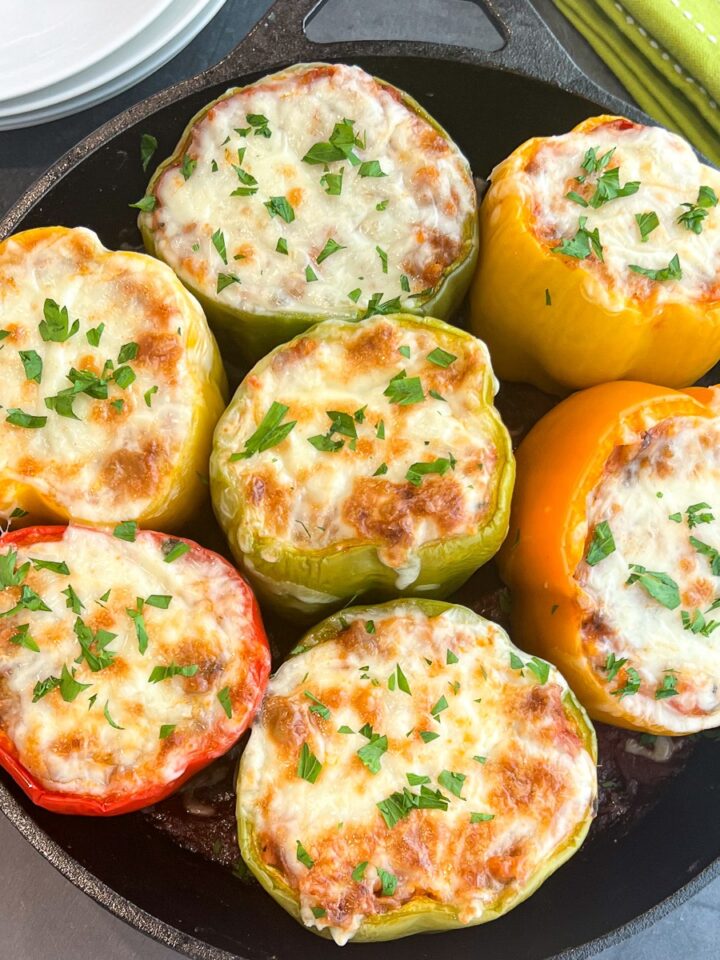 Sausage stuffed peppers in a cast iron skillet