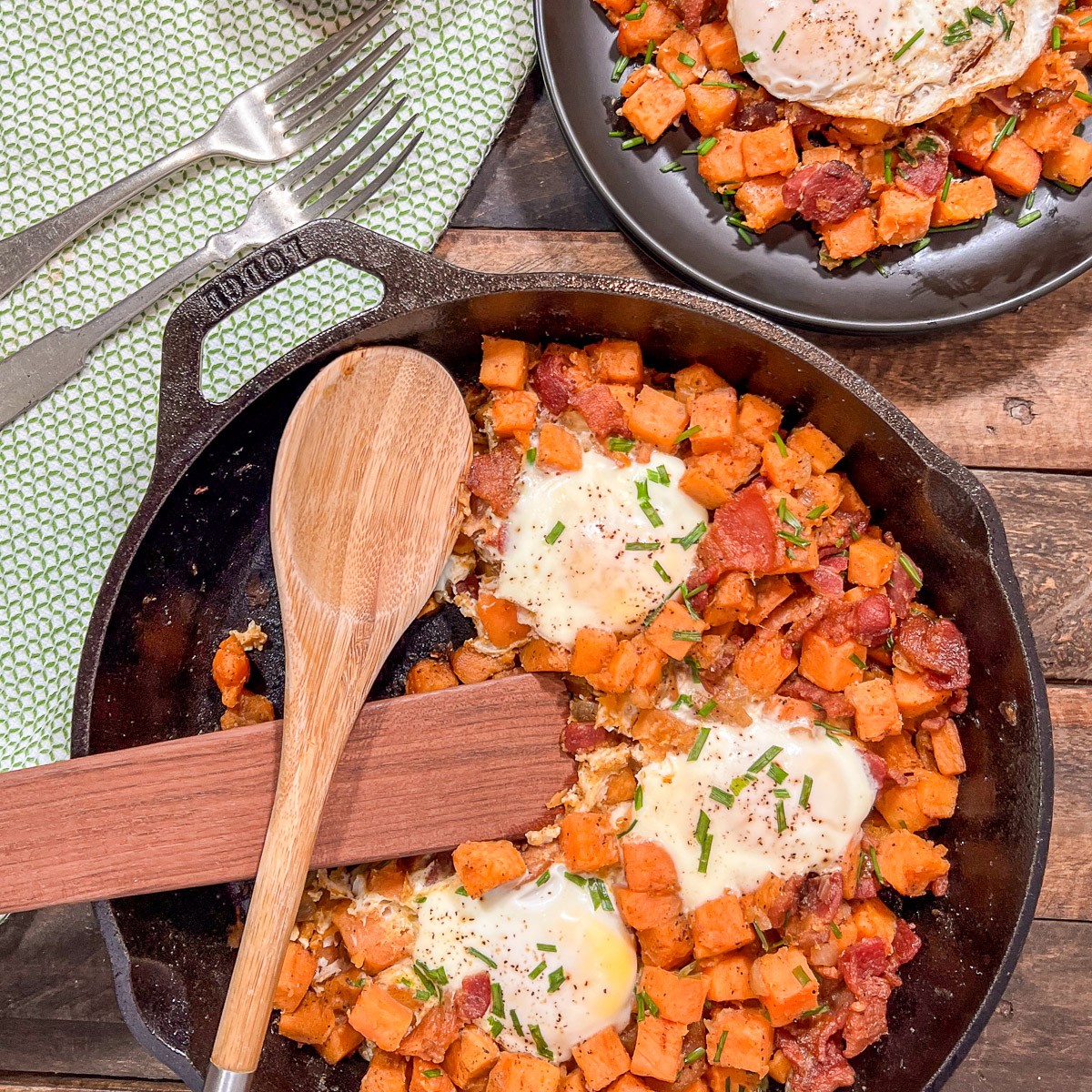 Sweet potato hash with eggs in a Lodge cast iron skillet ready to serve